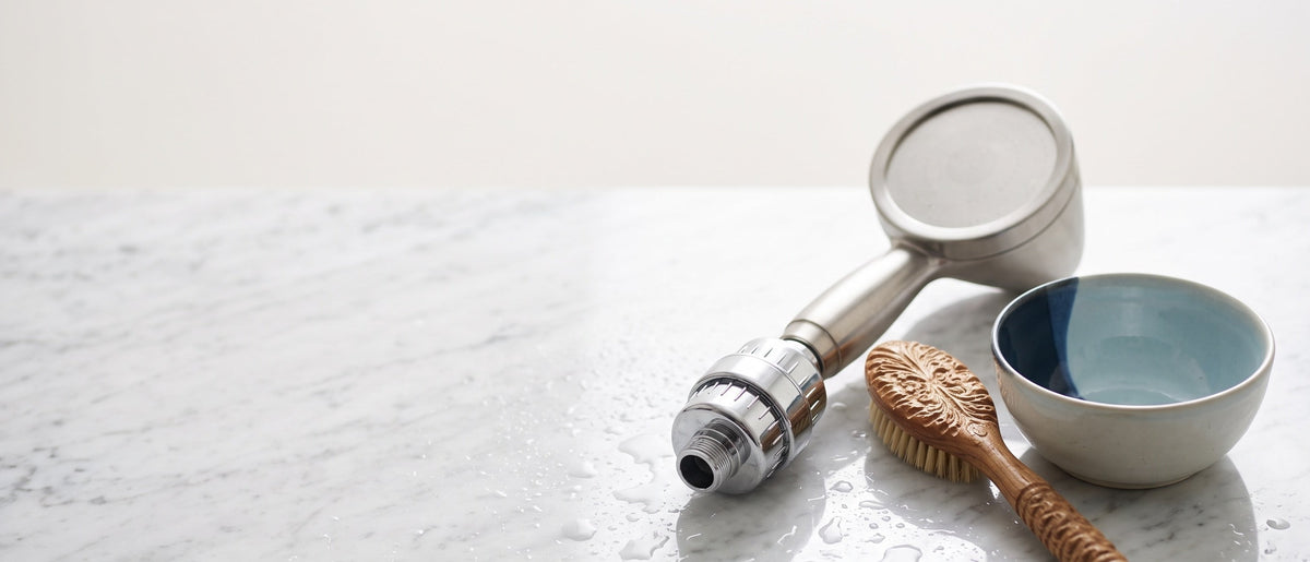 Korean bathroom fixtures: shower filter, wooden bath brush, and ceramic bowl